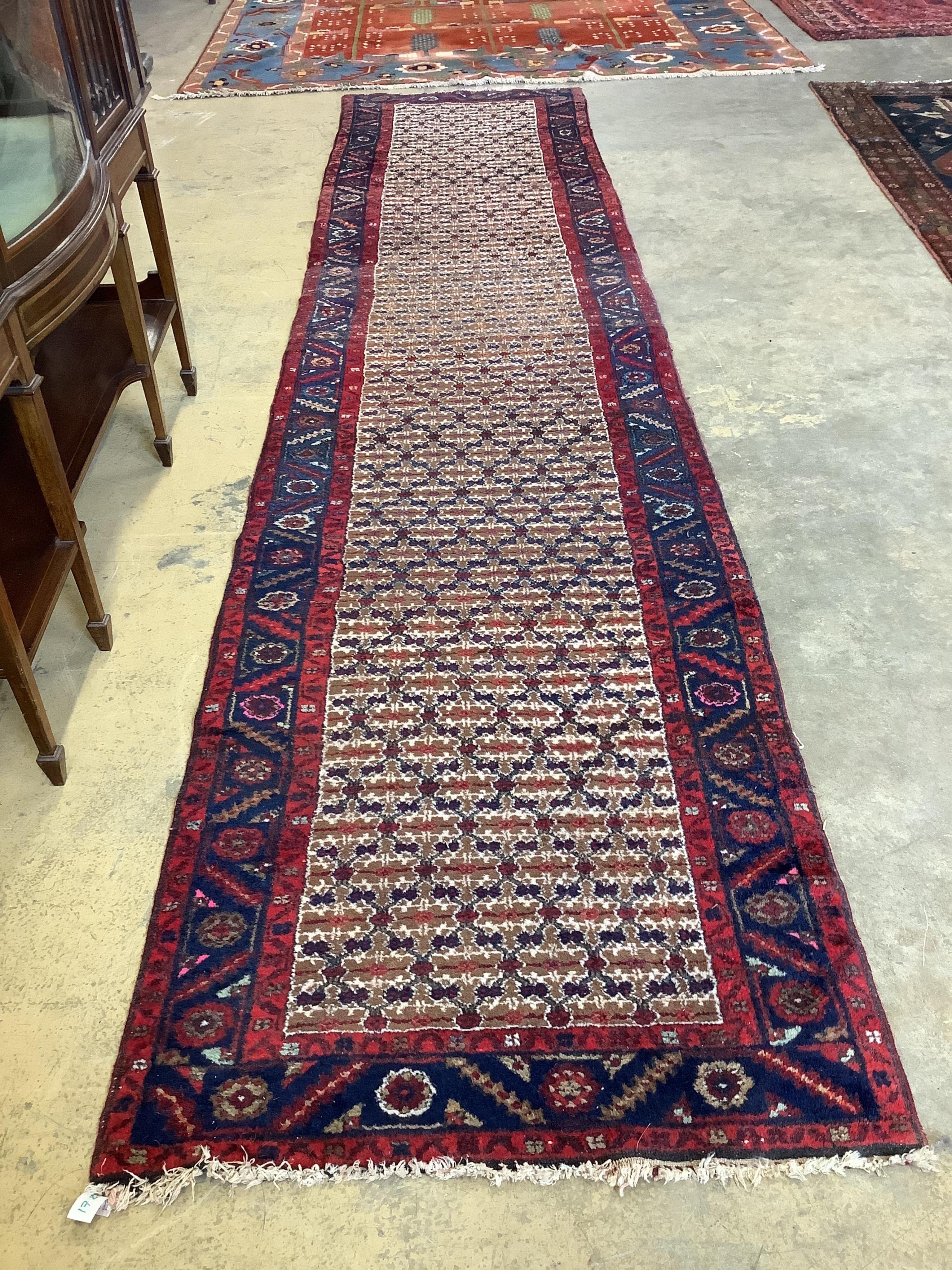 A modern Persian cream ground runner, 419 x 91cm. Condition - fair, but dog odour